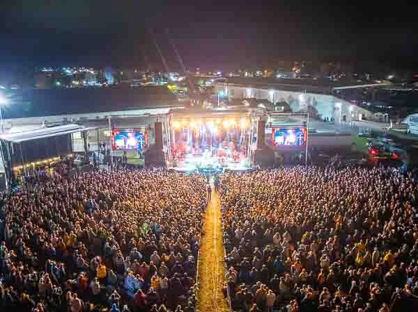 Sea of Souls - Healing Appalachia Unites at Night An aerial view of the vast Healing Appalachia crowd captivated by a nighttime performance.