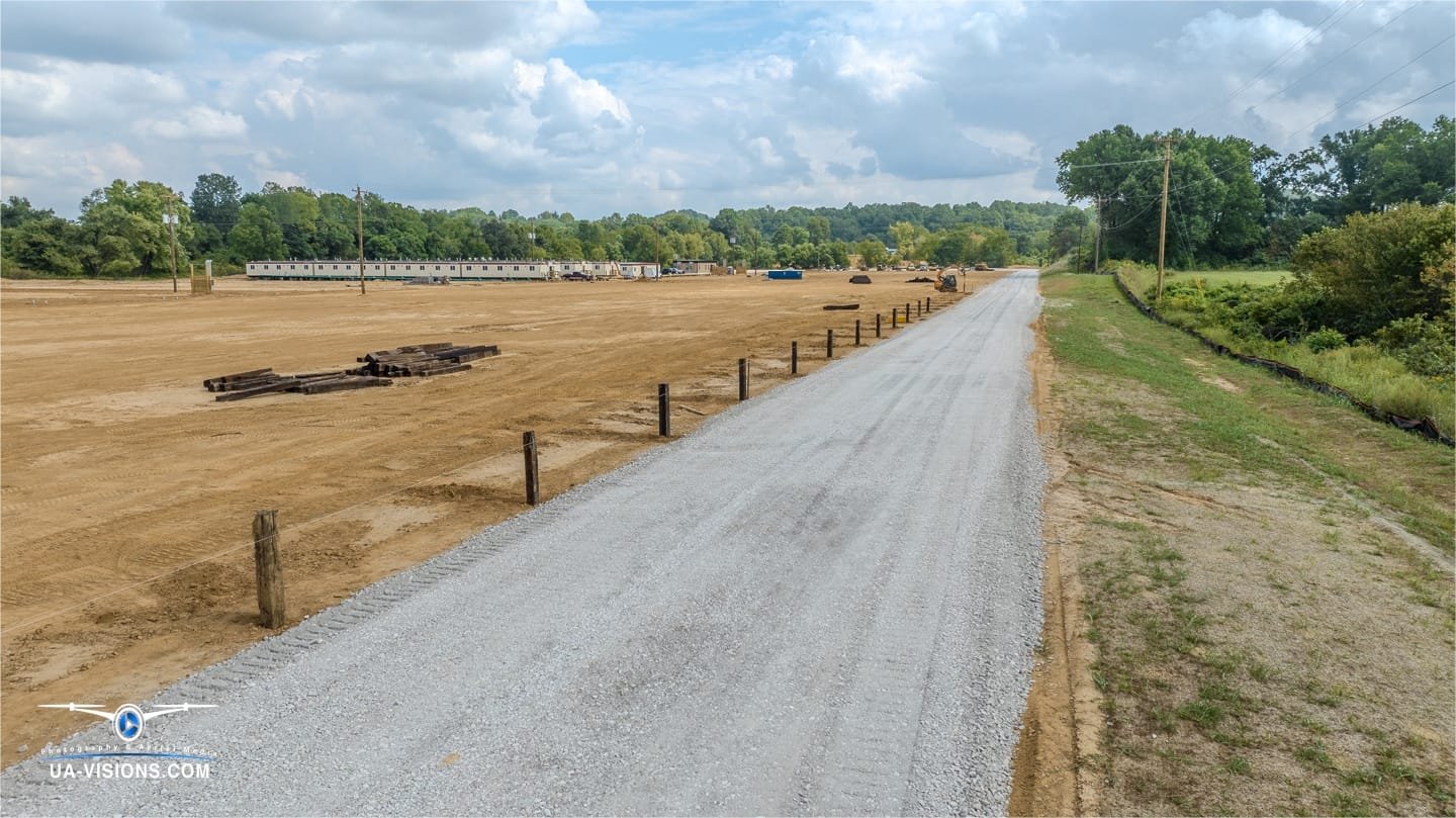 A gravel path weaves into SDRS's future, with UA-Visions capturing the route to Ashton's industrial evolution.