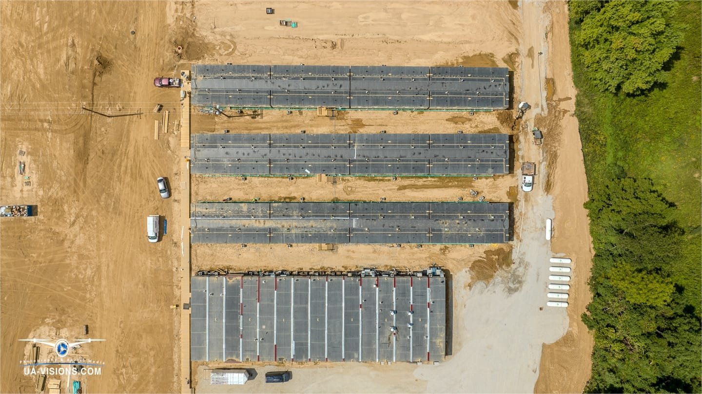 Piece by piece, Ashton's SDRS site assembles under UA-Visions' watchful flight, a testament to the industrious spirit.