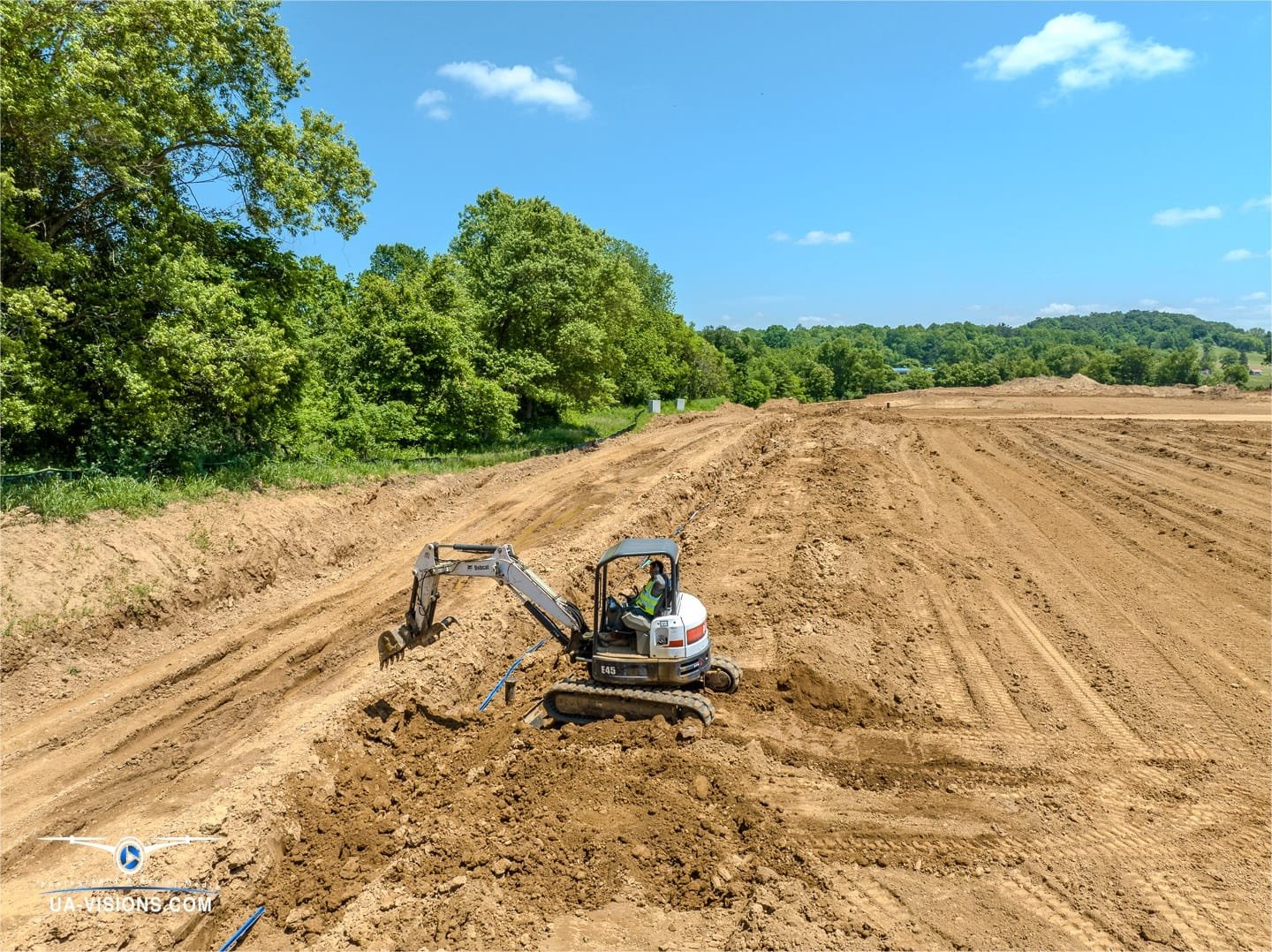 Over Ashton's SDRS site, UA-Visions captures the mastery of machinery sculpting the surface, a prelude to progress.