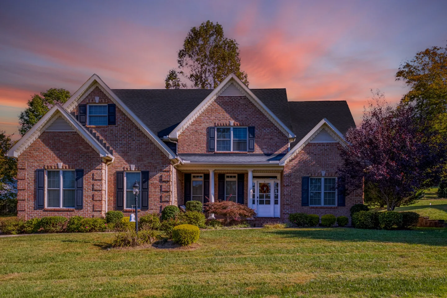 Twilight Elegance - Charleston Home Captured by UA-Visions Photography Twilight real estate photography of a brick family home in Charleston, WV, highlighting the property's elegant features at dusk.