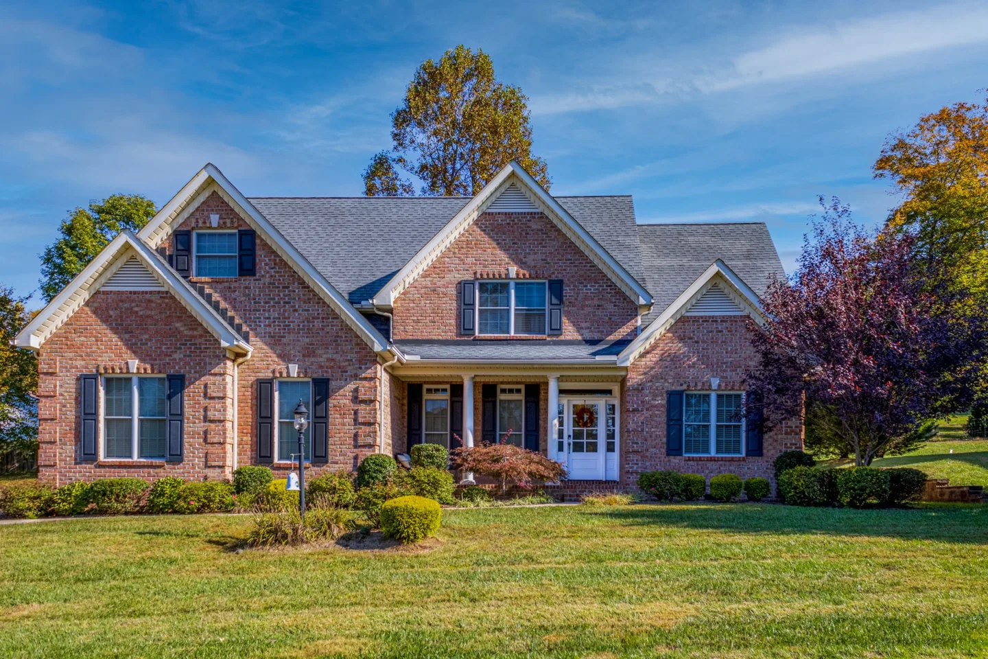 Elegant Family Home in Charleston - Exterior Photography by UA-Visions Professional exterior property shot of a brick family home with pristine landscaping, captured by UA-Visions in Charleston, WV.