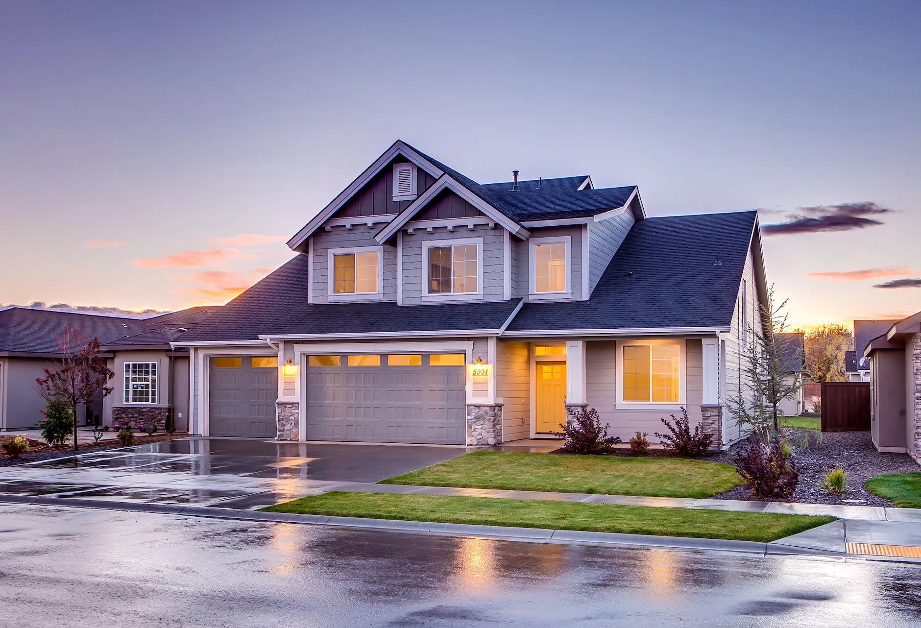 Professional Photography, Videography & Drone Services – Charleston WV UA-Visions Twilight photography of a two-story residential home with illuminated windows and wet driveway reflecting the sky, by UA-Visions.