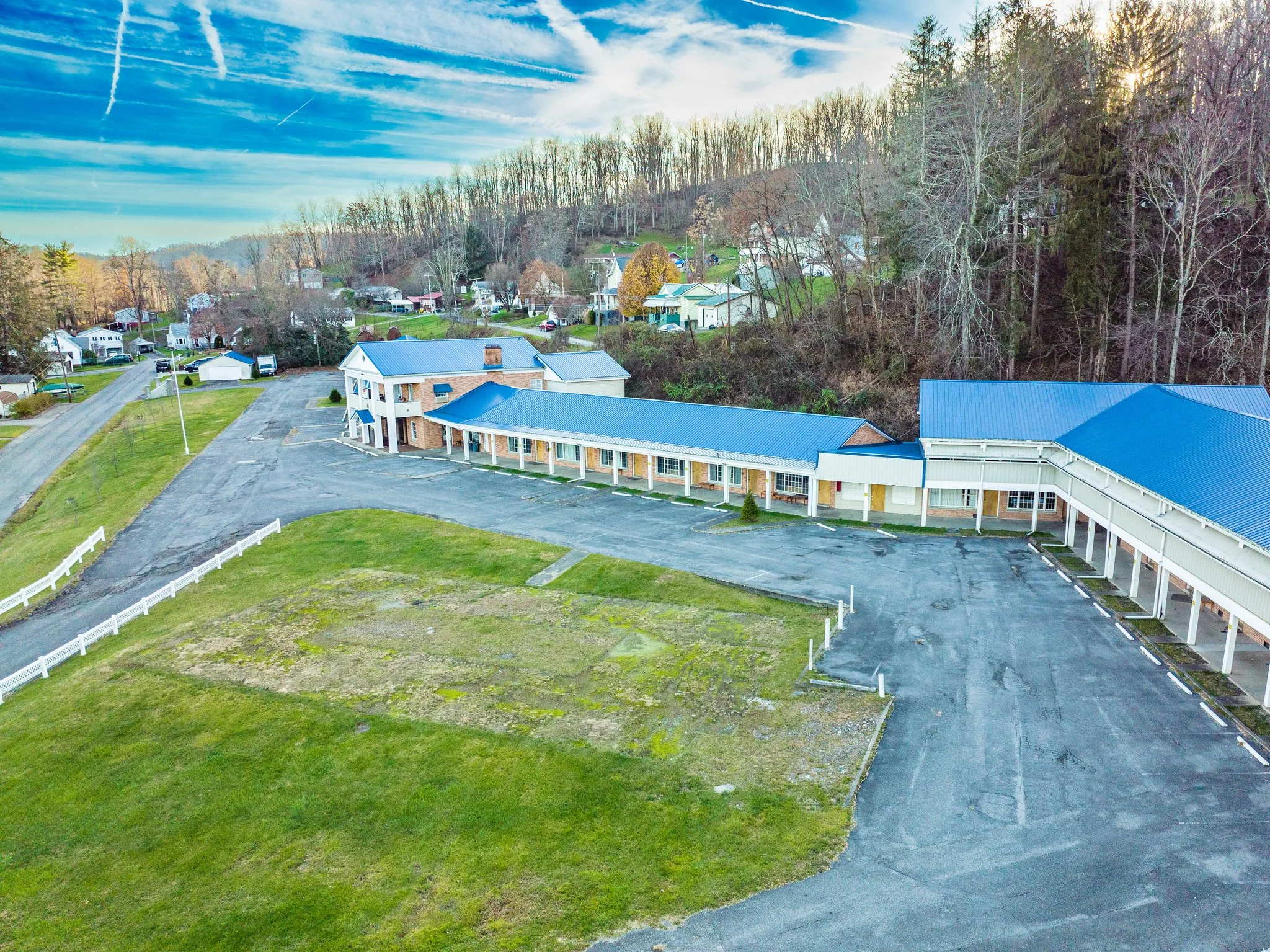 Our Portfolio of Digital Creations Oblique aerial view of Crislip Motor Lodge with its blue roofs and parking area