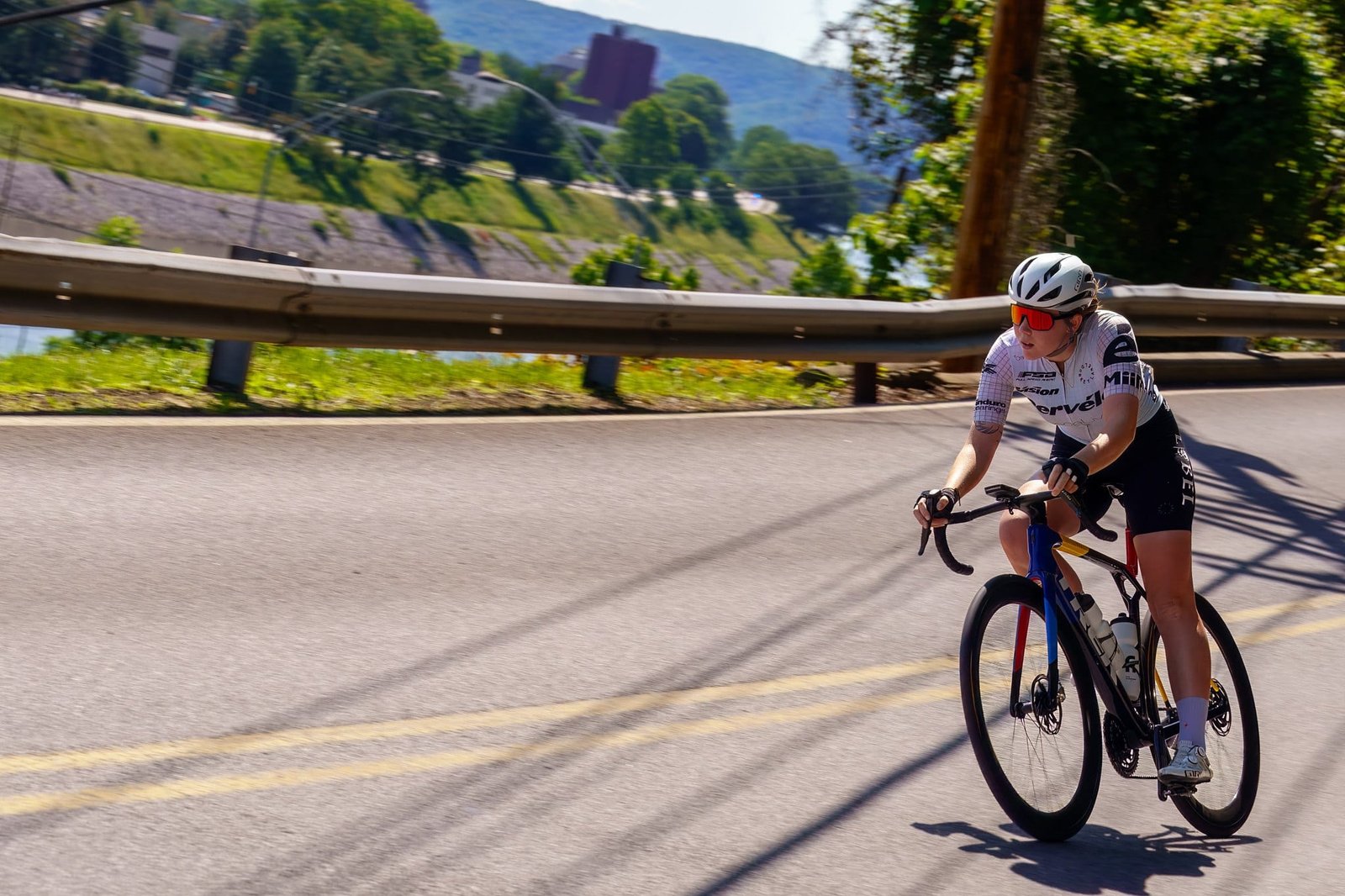 USA Cycling 2025 Photography and Video A cyclist riding a curving tree-lined road during the 2025 event